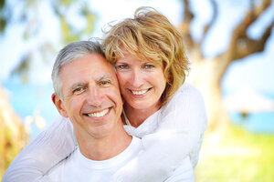 mature white couple near lake smiling with nice teeth dental veneers in Gaithersburg, MD